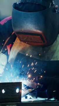Intense Close-Up of a Welder at Work, Showcasing Sparks and Precision Welding Techniques in Industrial Setting with Protective Gear and Focused Concentration
