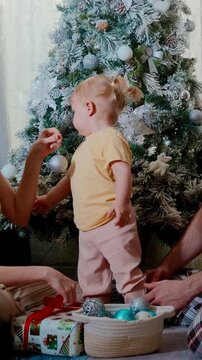 A Joyful Family Moment Around the Christmas Tree, Celebrating Togetherness and Festive Cheer with Gifts and Ornaments for a Special Holiday Experience
