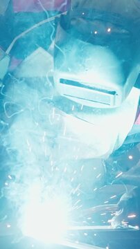 Intense Sparks and Blue Flame Emanate from a Welder's Torch in Action, Showcasing the Artistry and Power of Metal Fabrication Techniques