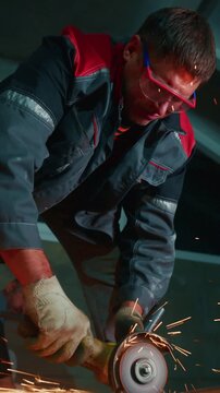 Skilled Worker Using Angle Grinder to Smooth Metal Surface While Sparks Fly in Industrial Workshop, Focused and Determined in Craftsmanship