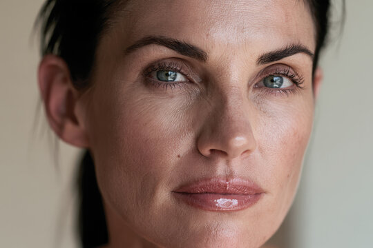 An intimate close-up portrait of a woman showcasing her authentic beauty and emotional depth with soft lighting and captivating features for stunning visuals.