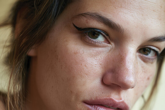 An intimate close-up portrait reflecting the natural beauty of a young woman, highlighting her features and the significance of self-acceptance in today's world.