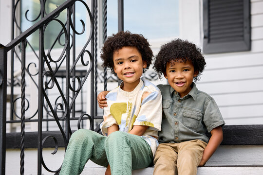 Two brothers smiling outside