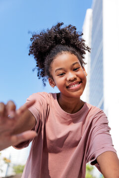 Happy girl facing the camera outdoors