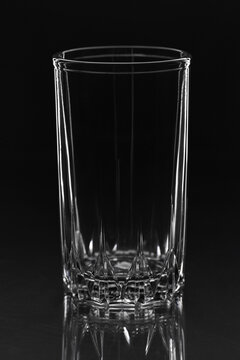 Empty water glass close up on black background