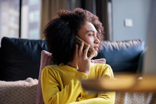 Woman rests at home and speaks via her phone