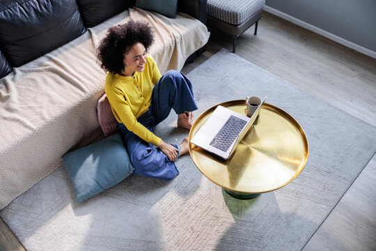 Woman watches content on a laptop at home