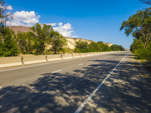 Paved Highway in Dry Hilly Landscape of Kyrgyzstan