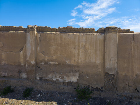 Damaged Concrete Wall Under Blue Sky in Kyrgyzstan