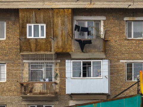 Exterior of Brick Apartment Building with Balconies and Laundry