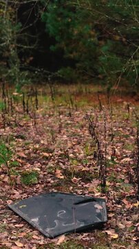 A destroyed military drone lies in a forest, highlighting environmental damage caused by the Russia-Ukraine war in Europe, including debris pollution and threats to the natural ecosystem.