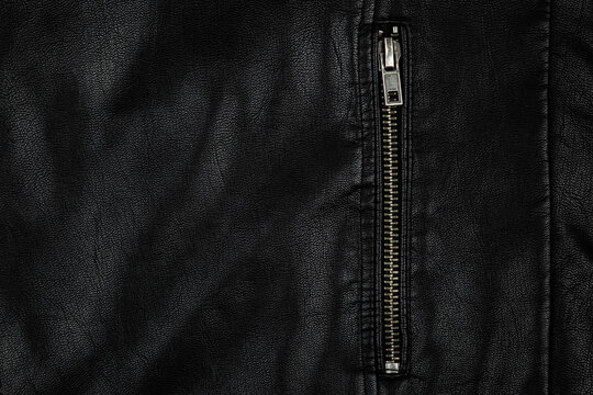 Black leather jacket detail with metal zipper