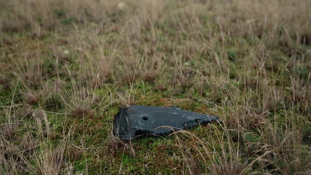 A destroyed military drone lies in a forest, highlighting environmental damage caused by the Russia-Ukraine war in Europe, including debris pollution and threats to the natural ecosystem.