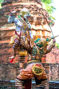 Two Thai Khon performers in full costume as the white monkey warrior Hanuman and the demon king Thosakan performing traditional and legendary rivalry from the Ramayana Thai famous literature outdoor
