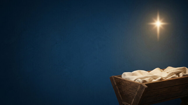 Wooden manger with white cloth under a bright star on blue background. Holy night nativity scene.
