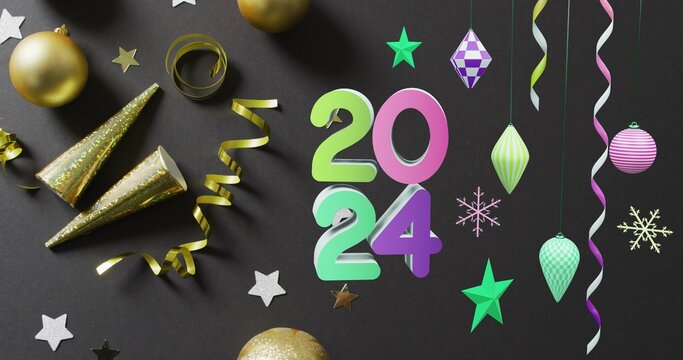 Large colorful 2024 numerals standing on dark matte surface with gold baubles and ribbons