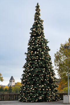 Christmas tree in Luxembourg city, decorated fir with golden baubles, stars and lights, winter holiday season, tall pine at place de la constitution