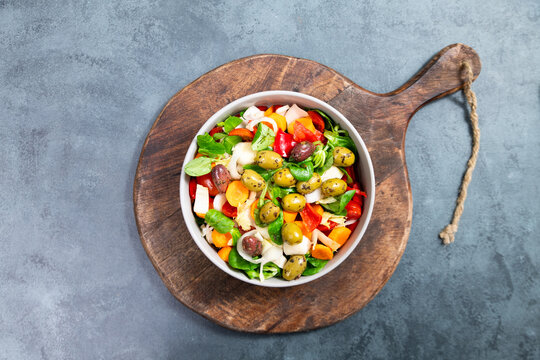 Salad bowl with lettuce, chicory, olives, cucumber, spinach, tomatoes and herbs, healthy mediterranean food, homemade meal, lifestyle and nutrition diet
