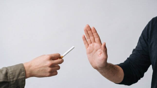 A person refusing to accept an unlit cigarette offered by another individual against white background