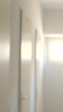 Blurry school hallway with row of closed classroom doors leading to,