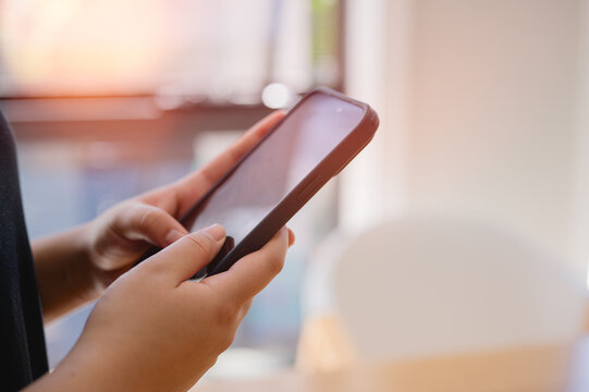 Social media marketing concept. Woman hand using smartphone typing, chatting conversation in chat box icons pop up