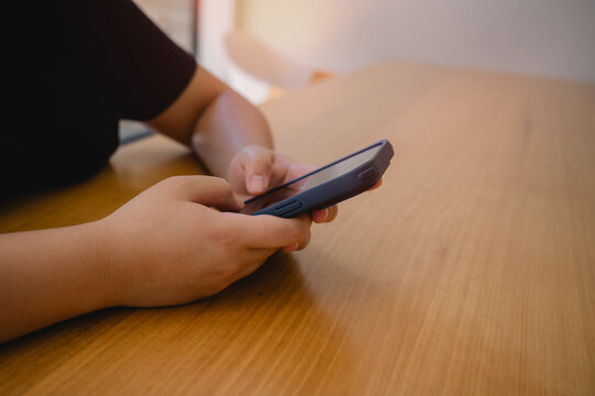 Social media marketing concept. Woman hand using smartphone typing, chatting conversation in chat box icons pop up