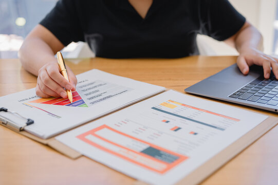 Risk management and workplace safety concept, woman working with clipboard and hazard report on table in modern office.