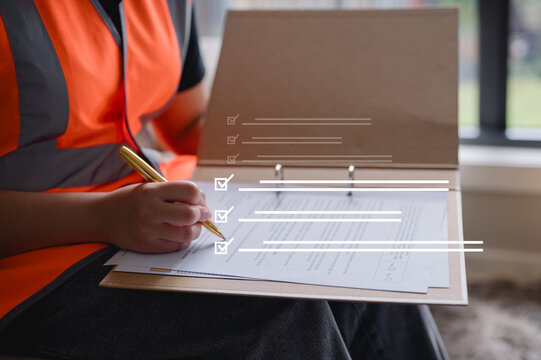 Foreman or engineer using pen and clipboard data checking on report and working at construction site Quality control, maintenance, check in factory, warehouse Workshop for factory operators