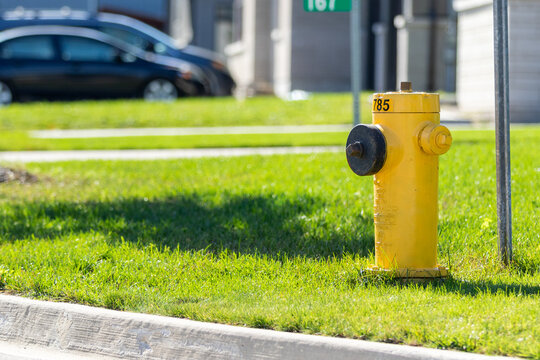 Yellow fire hydrant in modern residential subdivision
