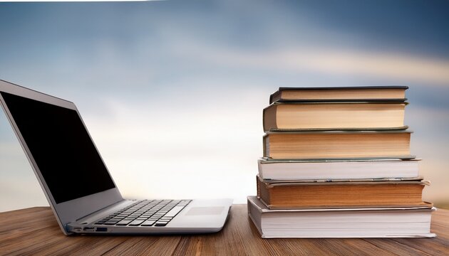 stack of books with laptop on wooden table