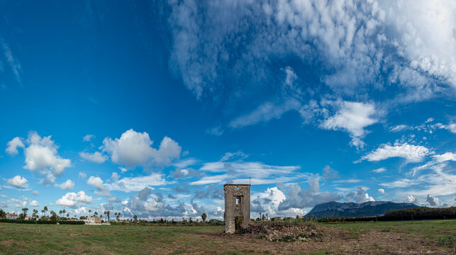 Panoramic view of an ancient stone tower ruin in a rural field u