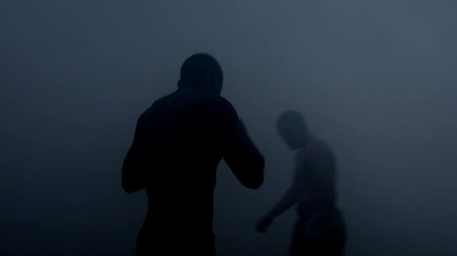 Two boxers sparring thick fog. Shirtless fighters facing off dark night battle.