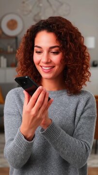Smiling woman holding smartphone