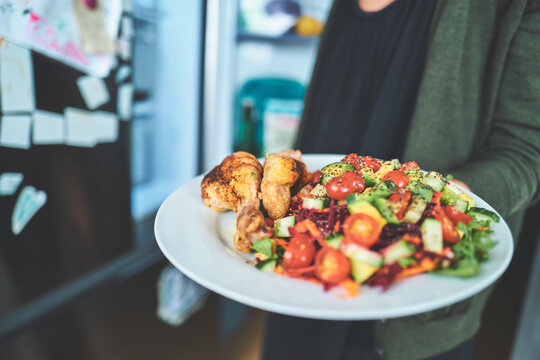 Plate of Roasted Chicken Drumsticks and Fresh Vegetable Salad