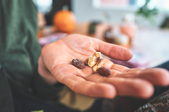 Woman Holding Walnuts and Almonds in Her Open Palm