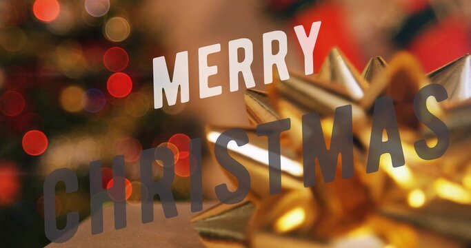 Large MERRY CHRISTMAS lettering glowing beside gold star bow over dark evergreen branches