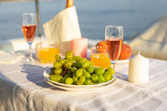 Romantic breakfast or dinner on a motor yacht. Hard sunlight.