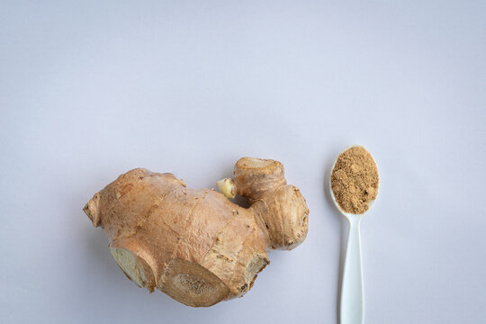Fresh Ginger Root and Ginger Powder on Spoon