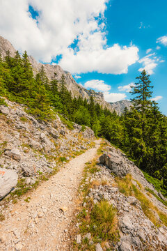 Alpine hiking trail from Prijevor in Bosnia to Trnovacko Lake in Montenegro, dramatic Dinaric Alps in Sutjeska park landscapes and crystal clear turquoise water.