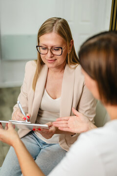 Female client completing paperwork during healthcare consultation