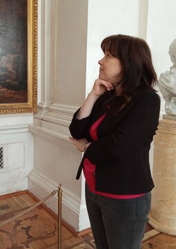 Thoughtful Mature Woman profile Portrait inside Art Gallery or Elegant Interior