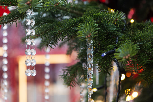 Pine branch with crystal beads. Garland wire. Golden bokeh background. Background for New Year's or Christmas greetings