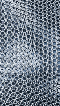 Metal chainmail fabric with interlinked steel rings forming protective