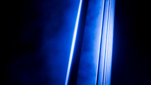 Blue neon light beams creating abstract vertical stripes effect