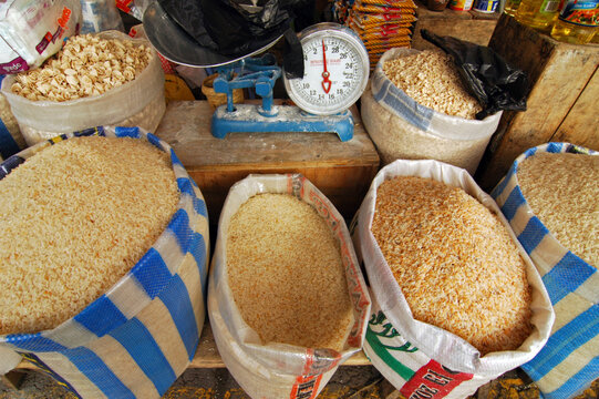 Open sacks of rice and grains with a weighing scale at a market stall, Cotopaxi, Saquisili, Ecuador