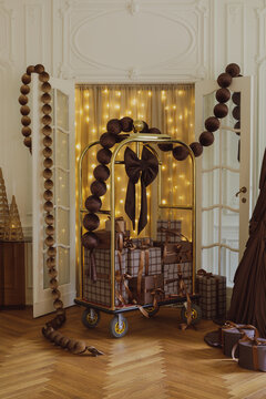 Luxury hotel luggage cart filled with elegant Christmas gift boxes decorated with festive brown velvet garlands and warm fairy lights in a grand interior