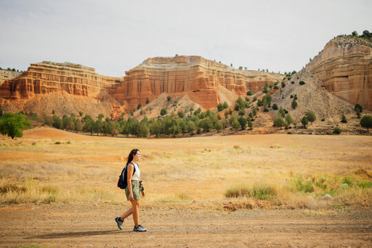Woman explores a desert canyon with a backpack