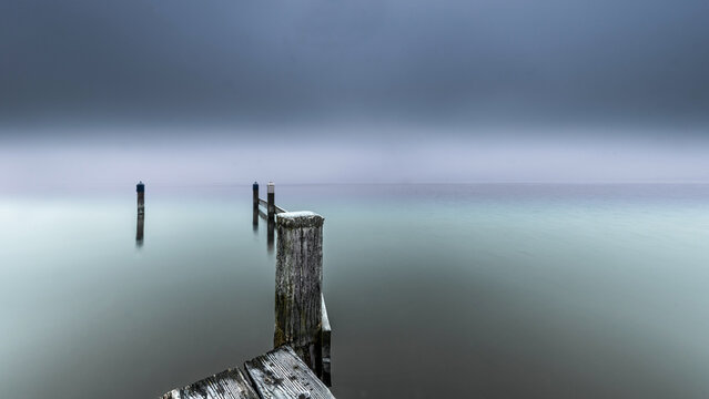 Foggy winter morning on jetty at Starnberger See lake Bavaria Germany