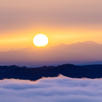 Sunrise over foggy hills and mountains at Lake Starnberg in Bavaria