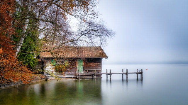 Boathouse on Lake Starnberg with morning mist in autumn